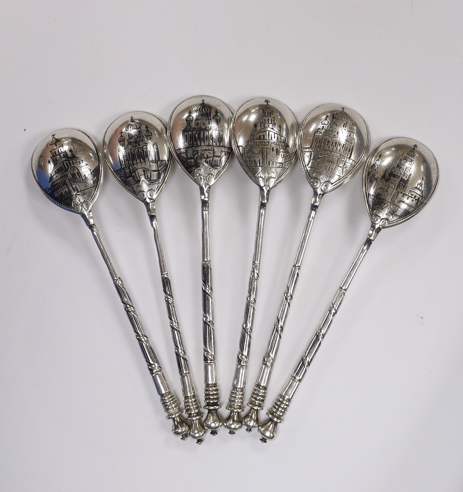 A set of six late 19th century Russian 84 zolotnik and niello teaspoons, the bowl backs decorated with building landmarks, master, Anatoly Artsibashov, 10.7cm, gross weight 82 grams.